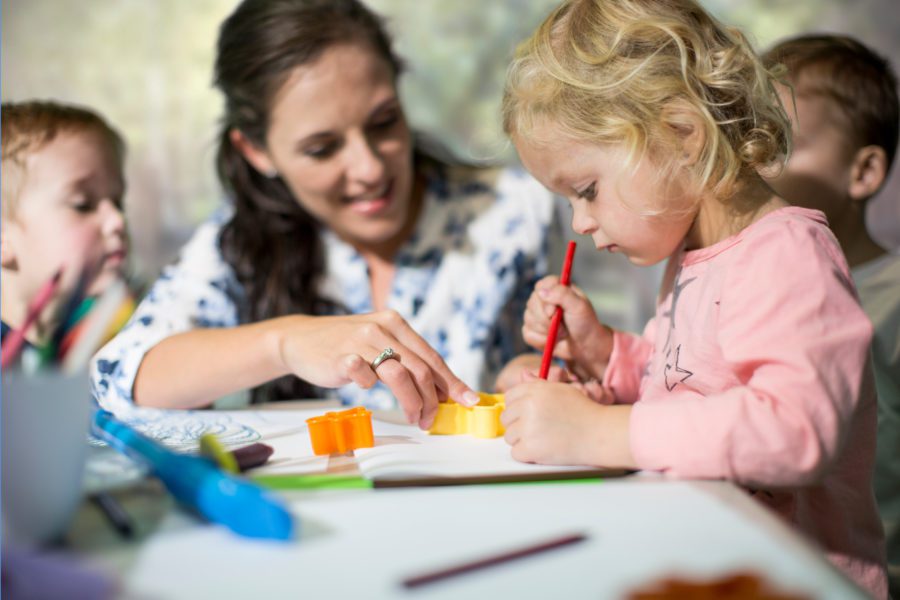Woman working with children at daycare