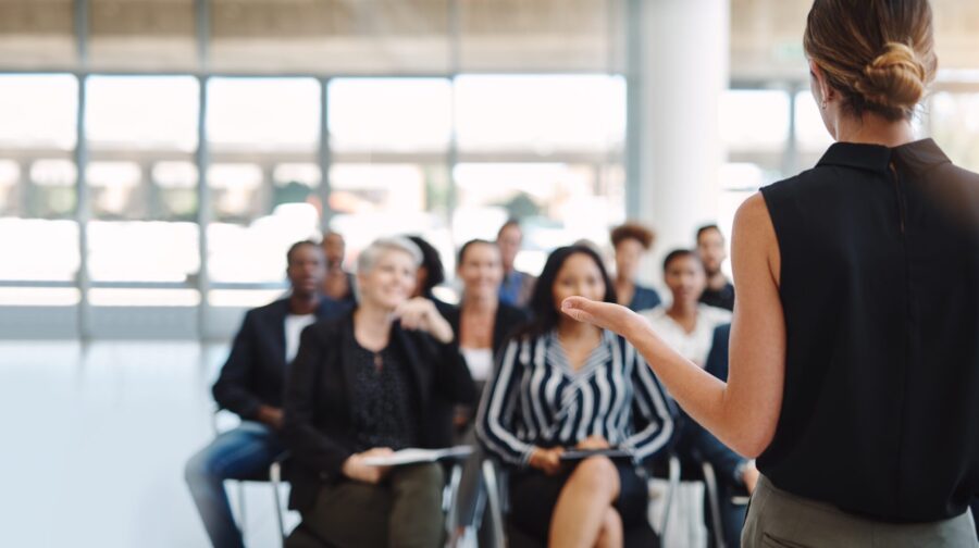 Shot of a young businesswoman delivering a speech during a conference